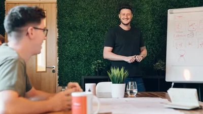 Andy smiles during a team meeting at the MadeByShape studio